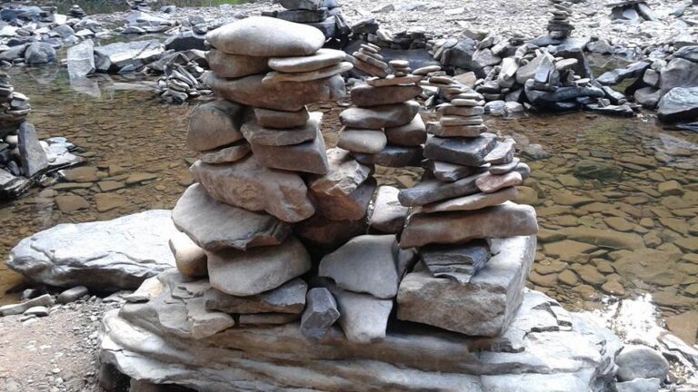 cairn of stones by a creek